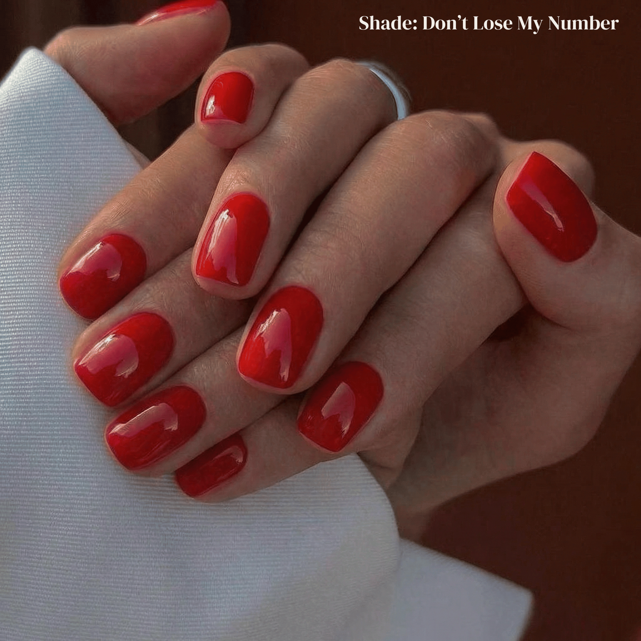 Close-up of hands with red nail polish on a blurred background