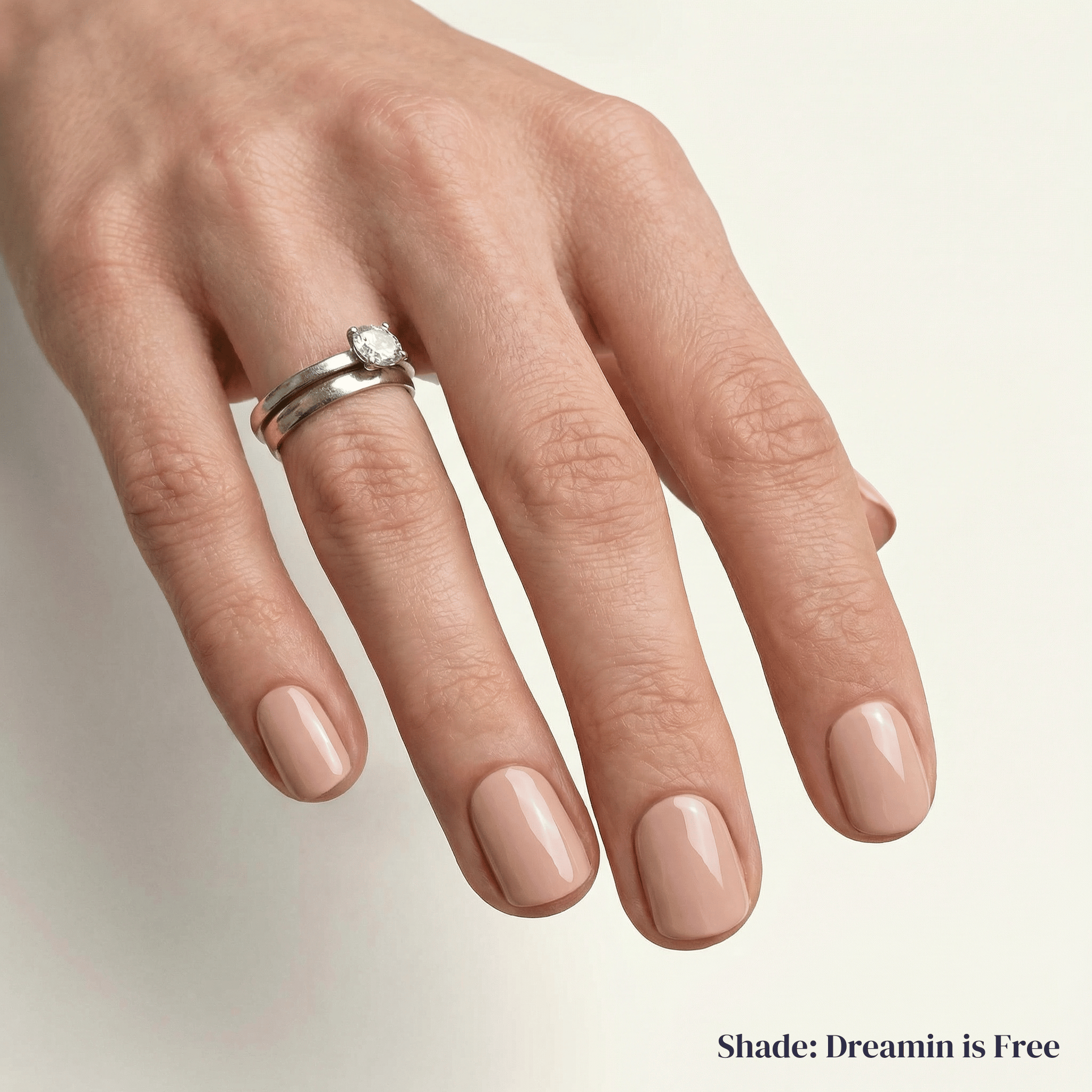 Hand with a ring on a neutral background