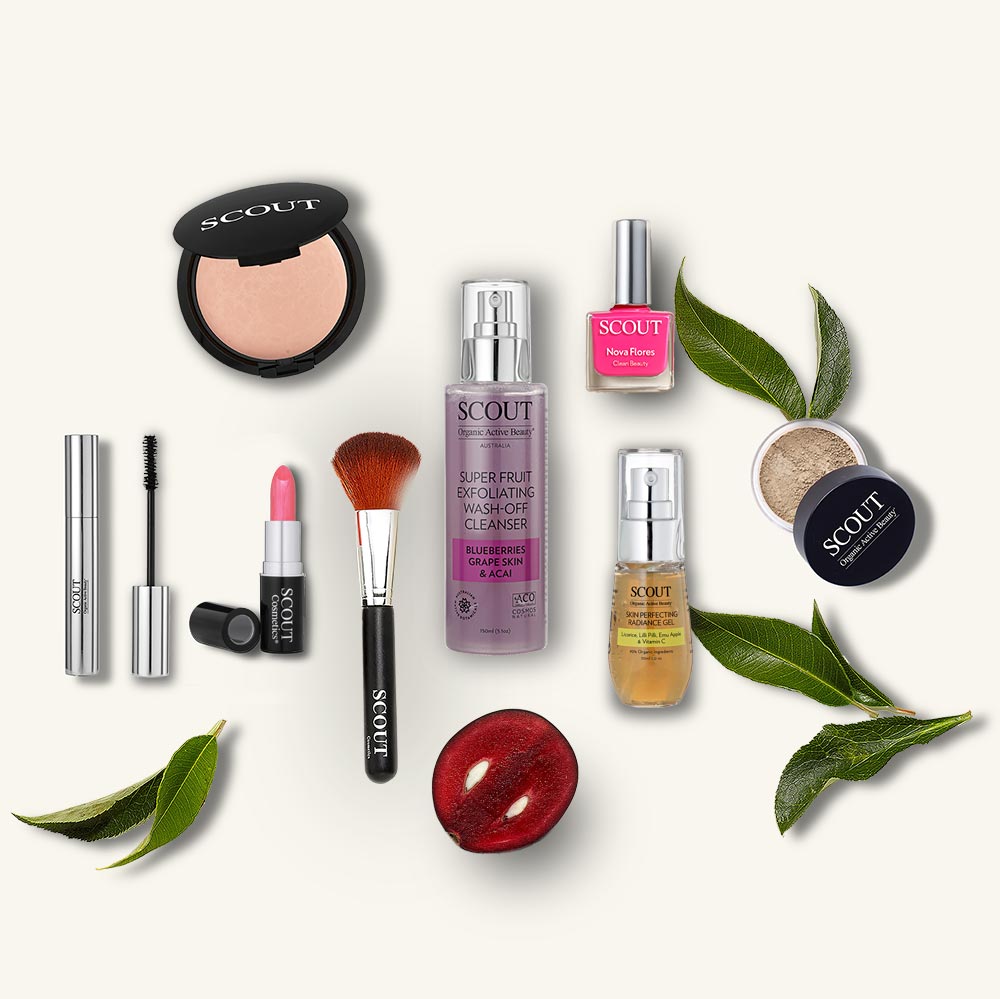 Collection of Scout skincare and makeup products on a white background with green leaves.