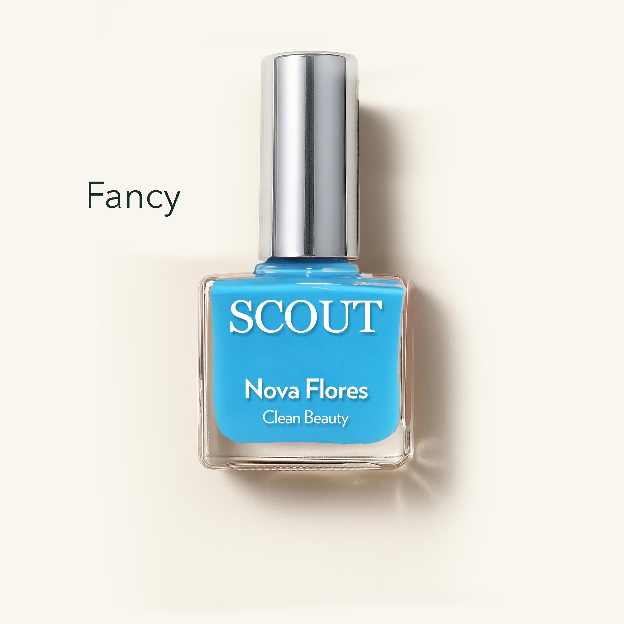 SCOUT nail polish bottle with blue polish on a light beige background