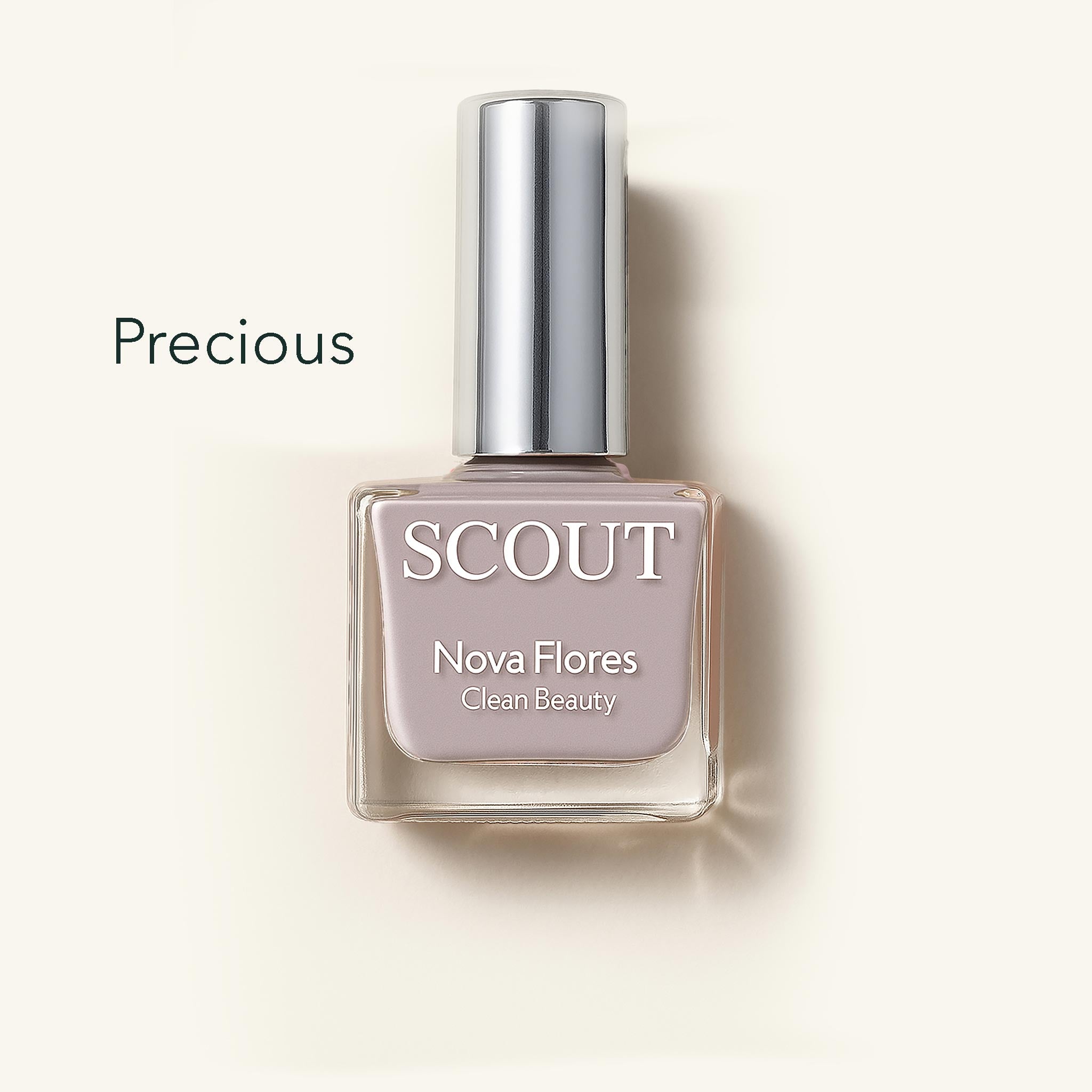 SCOUT nail polish bottle with silver cap on a light beige background