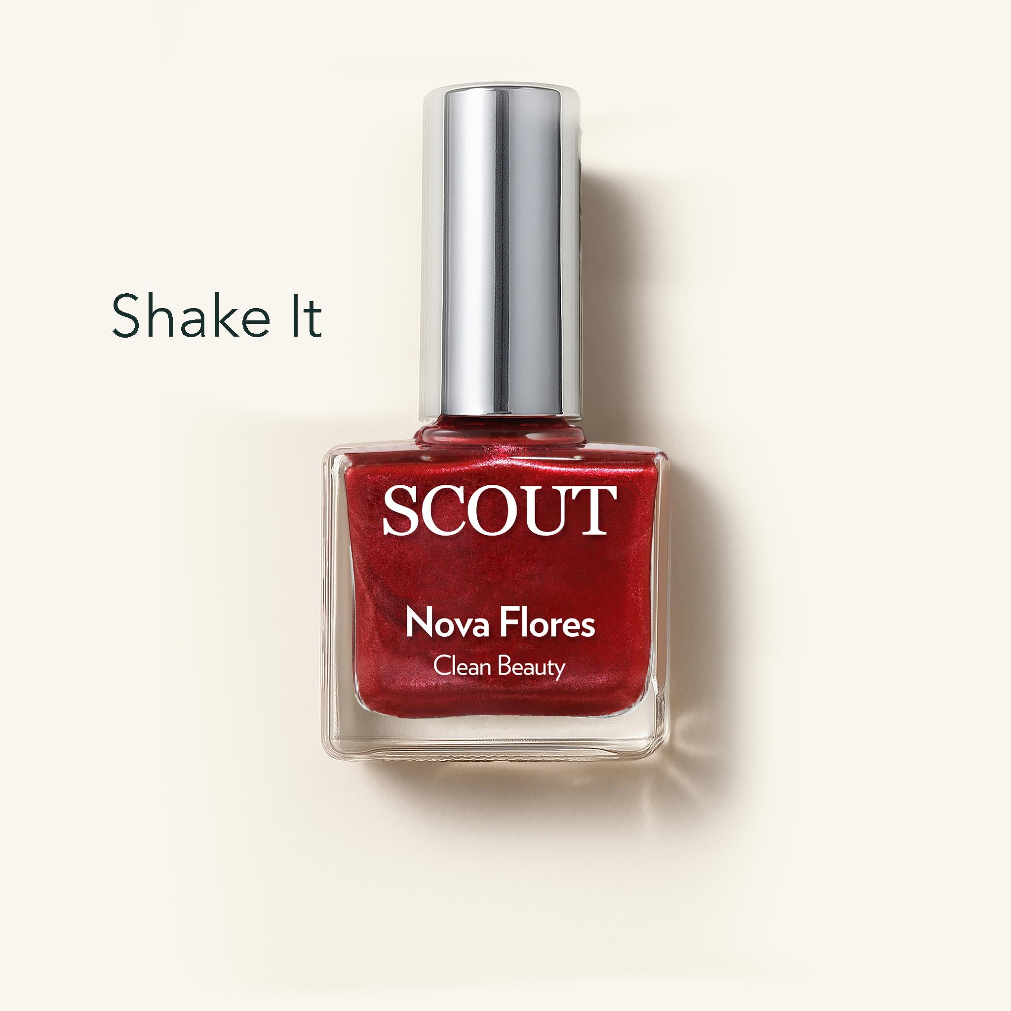 Red nail polish bottle with silver cap labeled 'SCOUT Nova Flores' on a beige background.