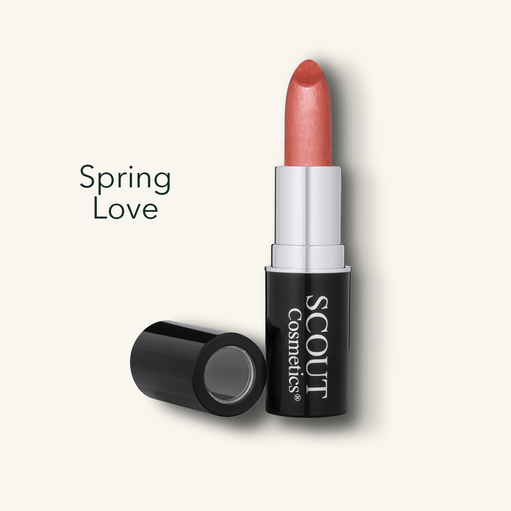Lipstick with 'Spring Love' shade and 'SCOUT Cosmetics' branding on a light bone color background