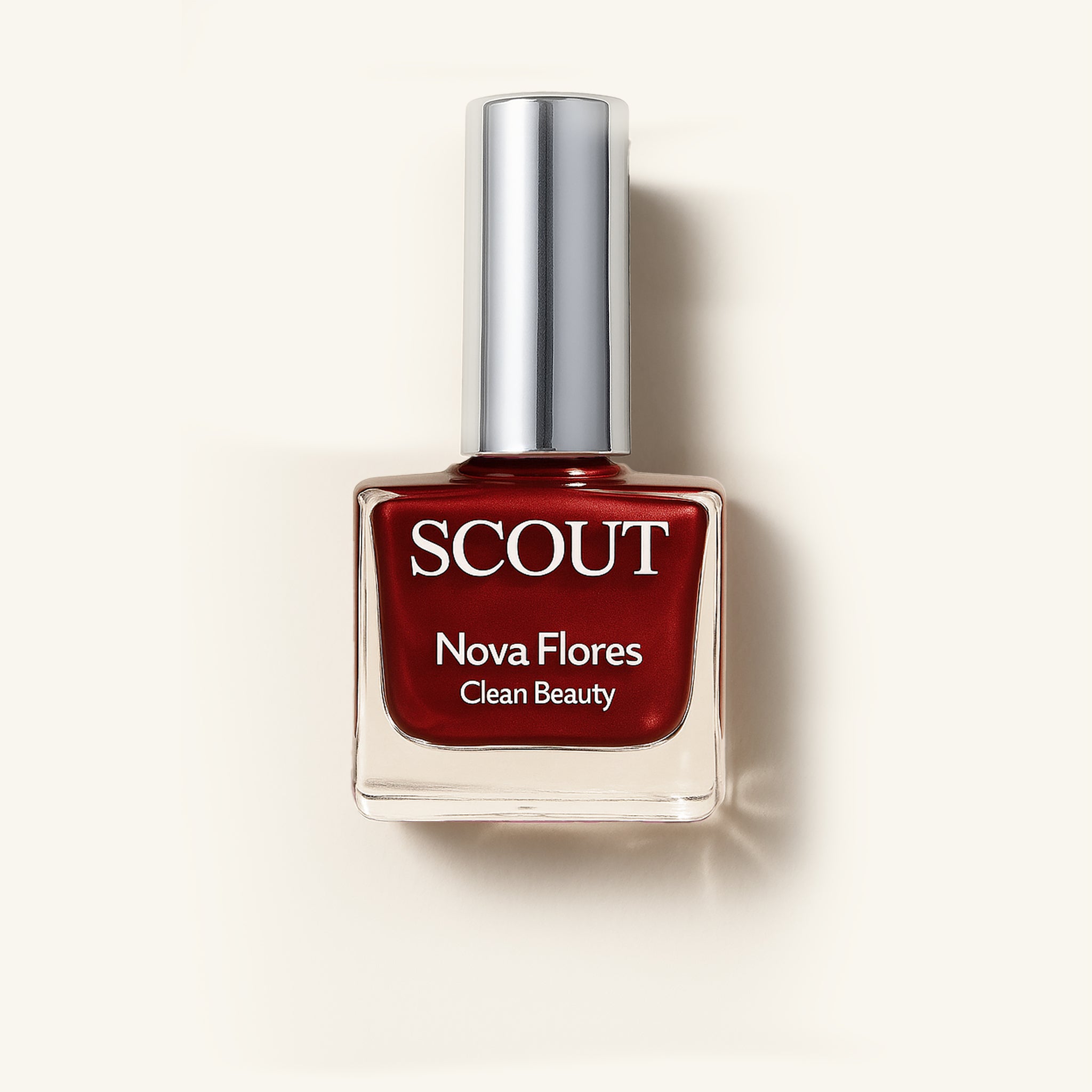 A bottle of red nail polish labeled 'SCOUT Nova Flores Clean Beauty' on a light background. Made in Australia, Superfood Ingredients. Toxic Free, Highly-Effective, Vegan. Protect nail health.