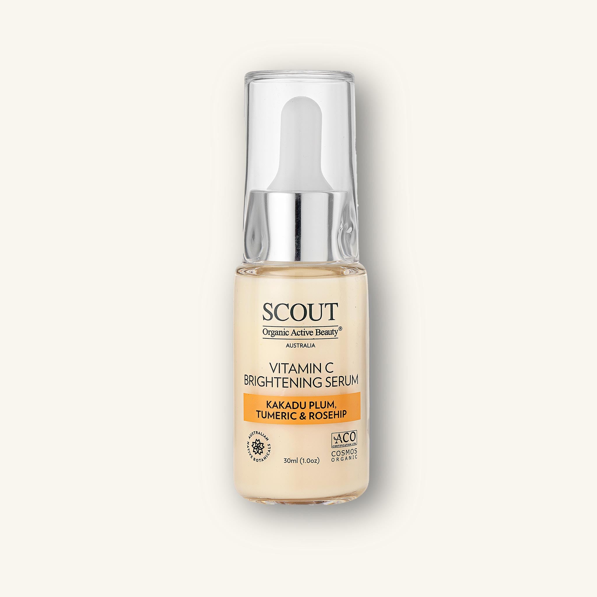 Studio image of SCOUT Vitamin C Brightening Serum bottle with silver cap, featuring Kakadu Plum, Turmeric & Rosehip formulation on soft cream backdrop.