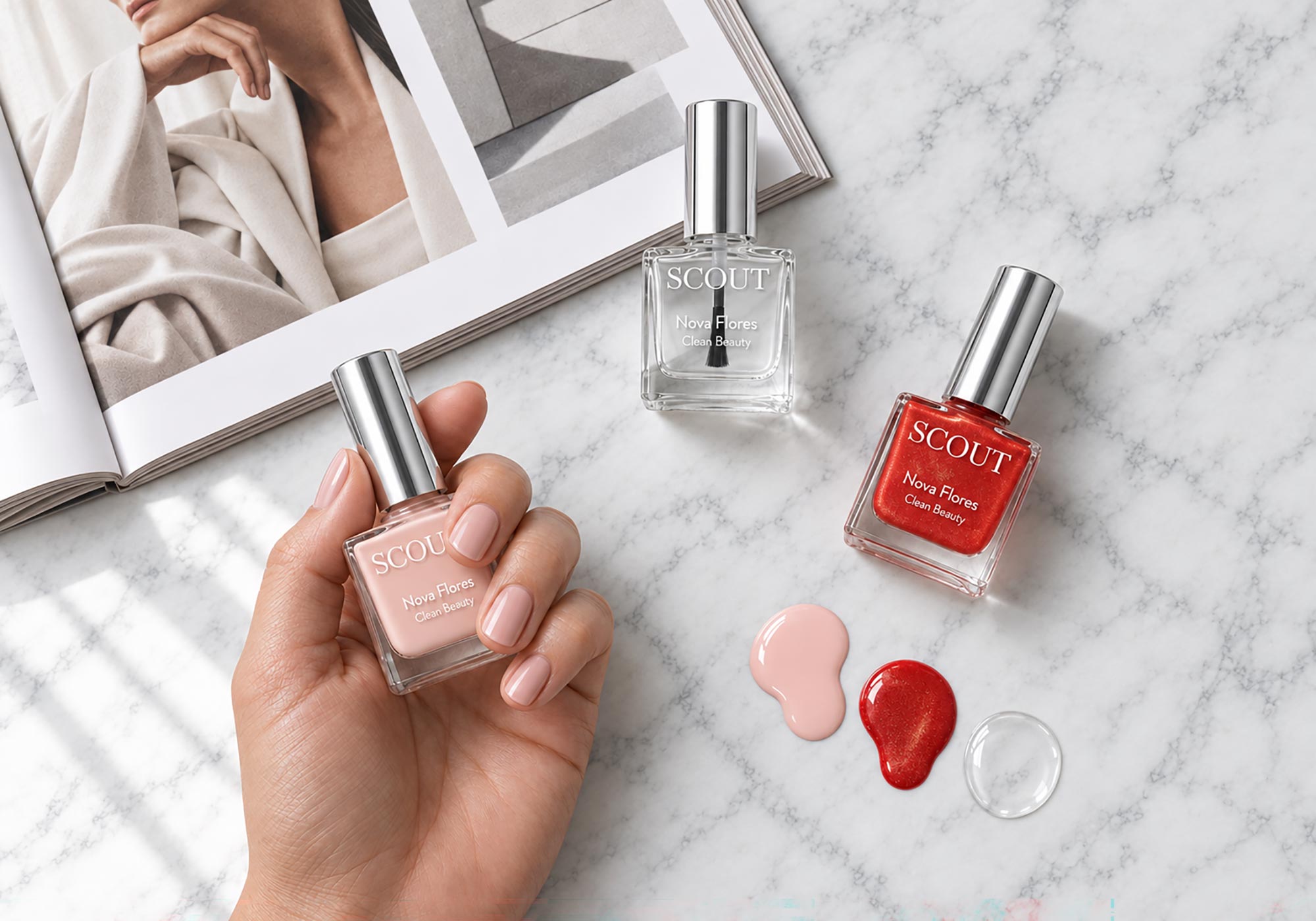 A hand holds a bottle of SCOUT New Polish Cherry Blossom nude pink nail polish, with two more bottles (one clear, one red) and three polish swatches on a white marble surface next to an open magazine.