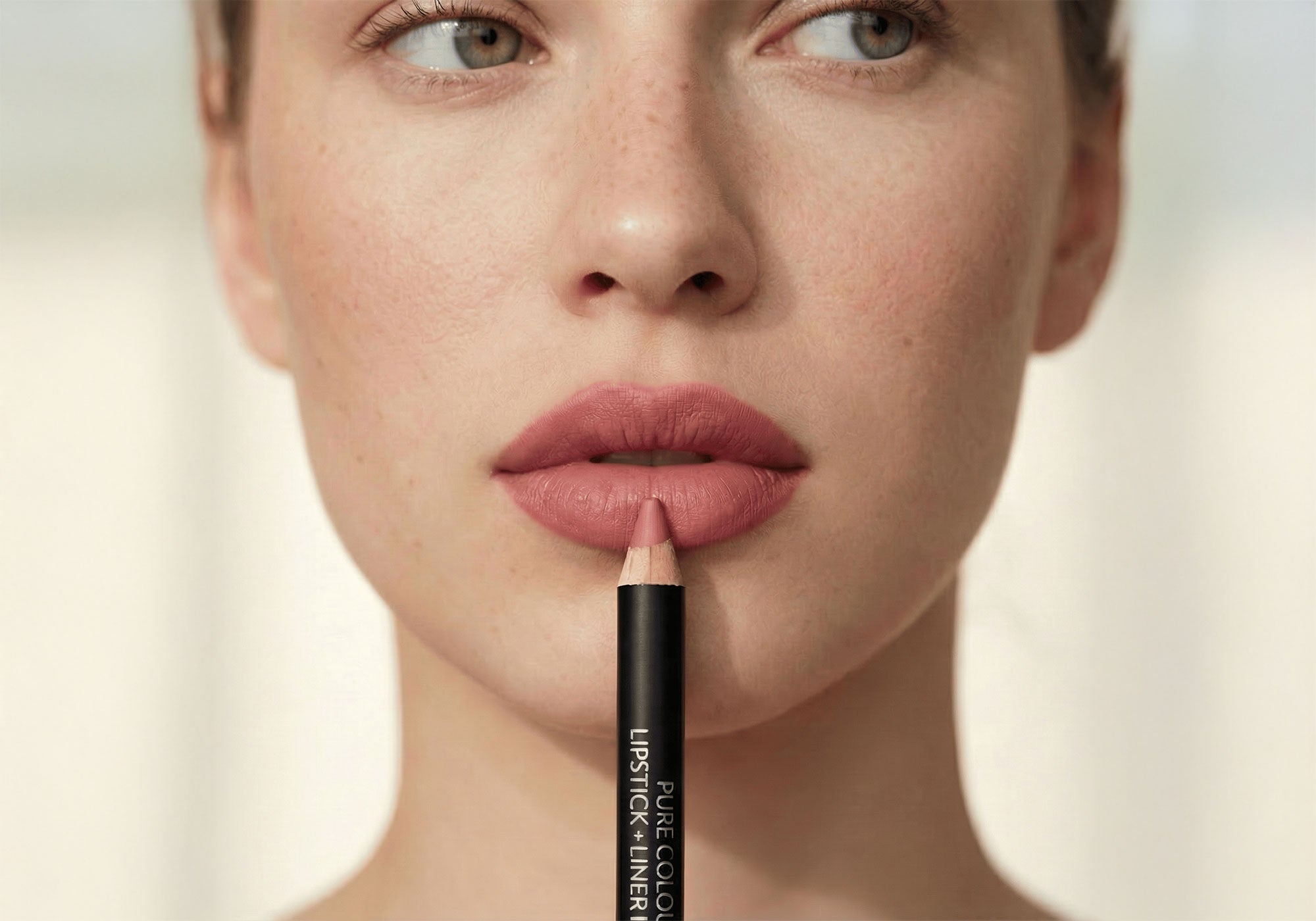 Close-up of a person applying lipstick with a focus on the product.