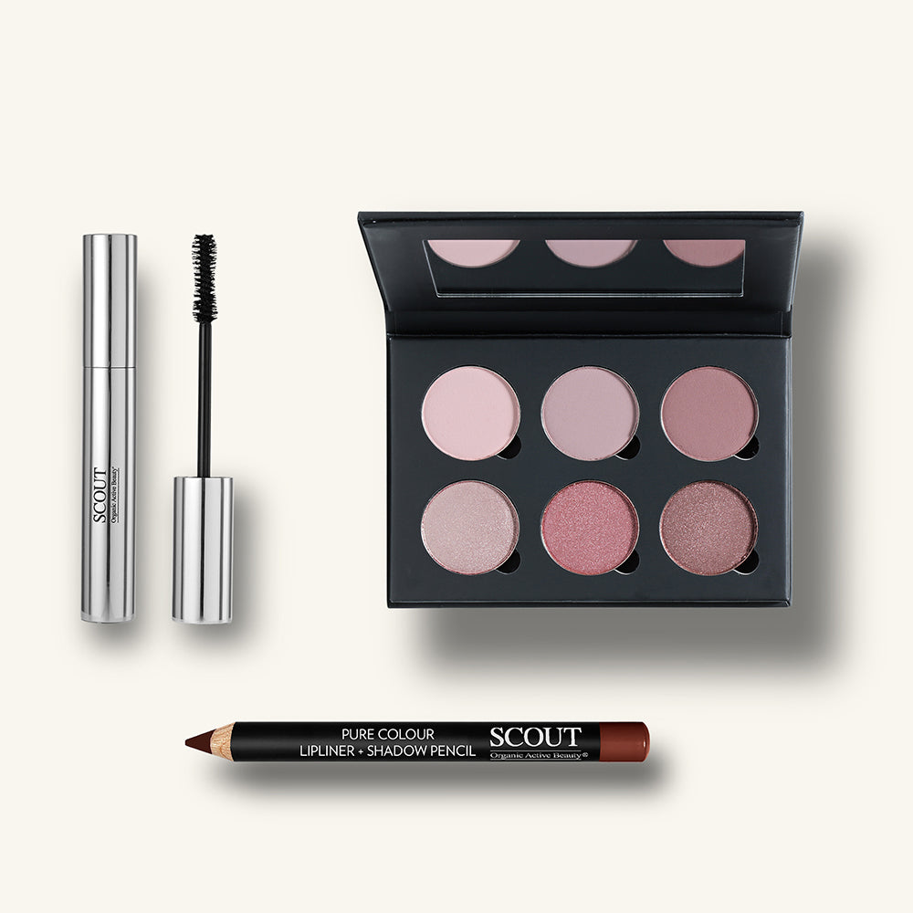 Scout makeup products including mascara, an eyeshadow palette, and a lip liner on a white background
