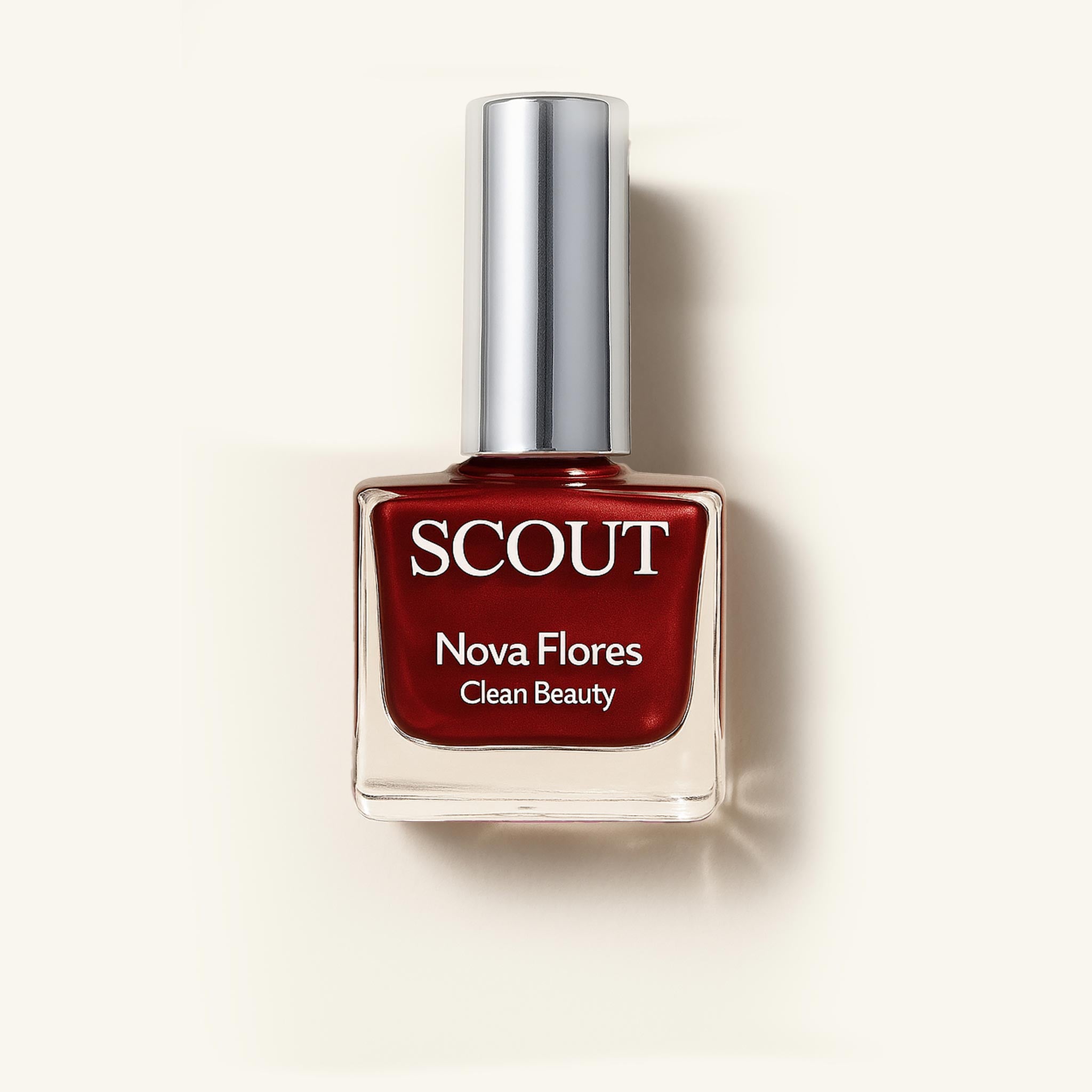 A bottle of red nail polish labeled 'SCOUT Nova Flores Clean Beauty' on a light background. Made in Australia, Superfood Ingredients. Toxic Free, Highly-Effective, Vegan. Protect nail health.